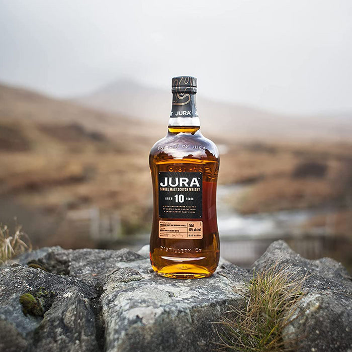 Jura 10 Year Old Whisky 70c in front of landscape 