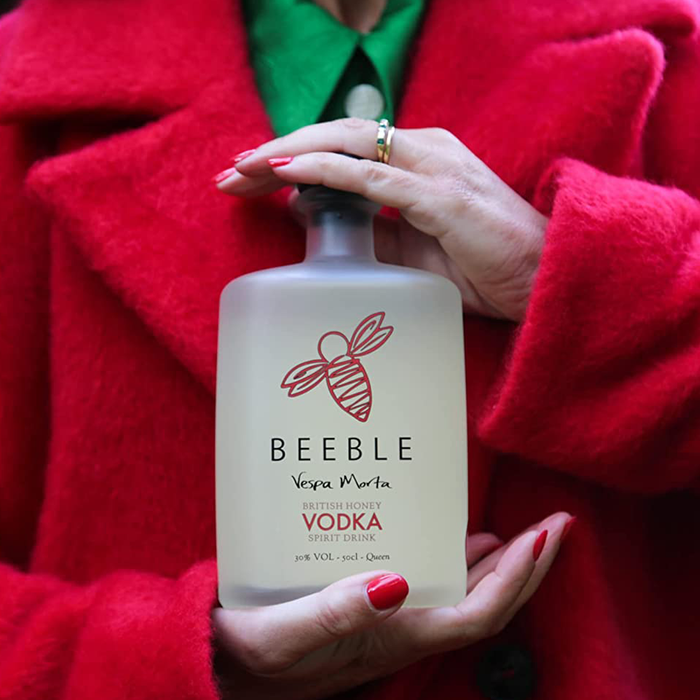 Women holding a bottle of Beeble Honey Vodka Secret Bottle SHop
