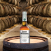 Bottle of Evan Williams Bottled In Bond Bourbon on top of a whisky barrel 