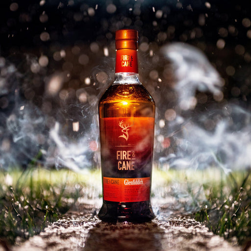 Bottle Of Fire And Cane Whisky At Night With Scotch Mist 