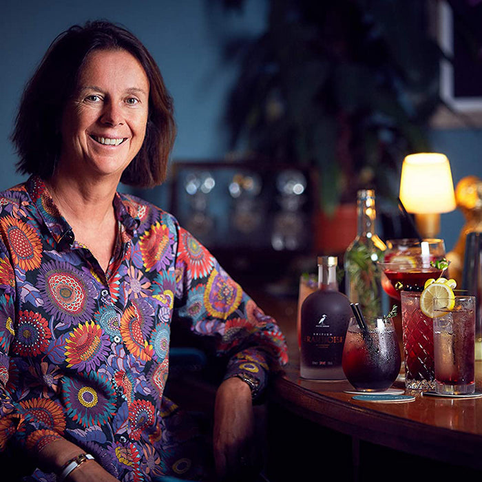 Happy Woman Next To British Cassis Framboise Raspberry Liqueur And Cocktails
