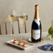 Nyetimber Classic Cuvee English Sparkling Wine And Two Glasses Of Wine With Three Salmon And Cream Cheese Canapes 